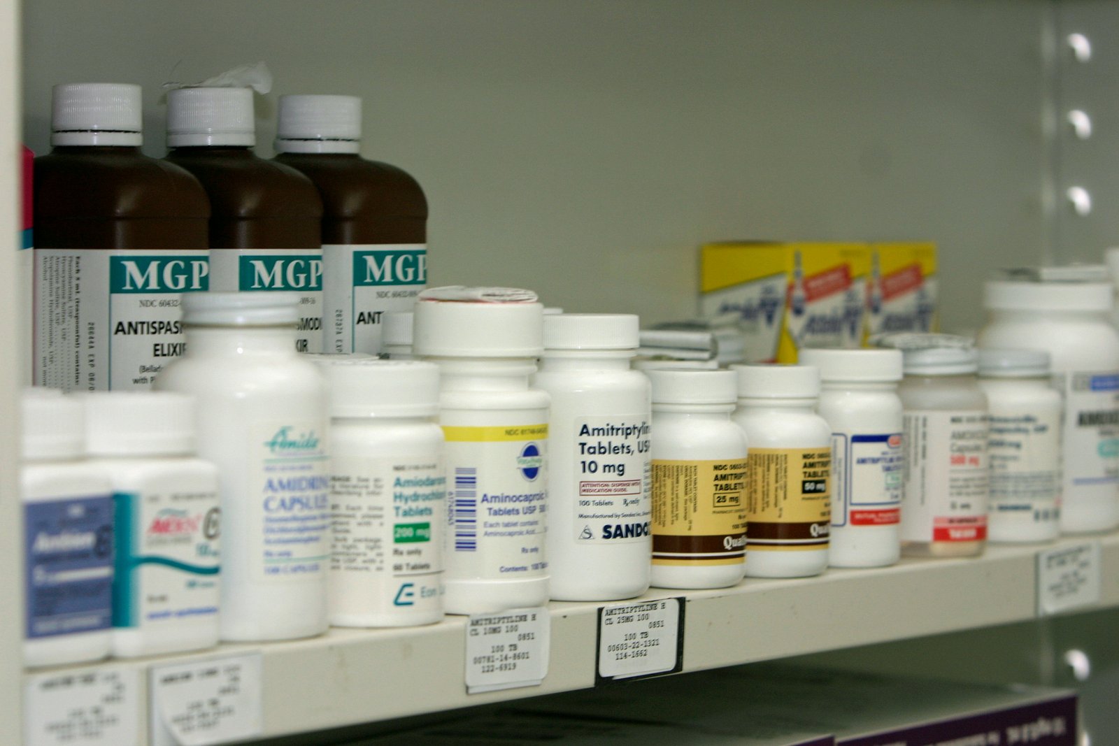 Pharmacy shelf stocked with medicines